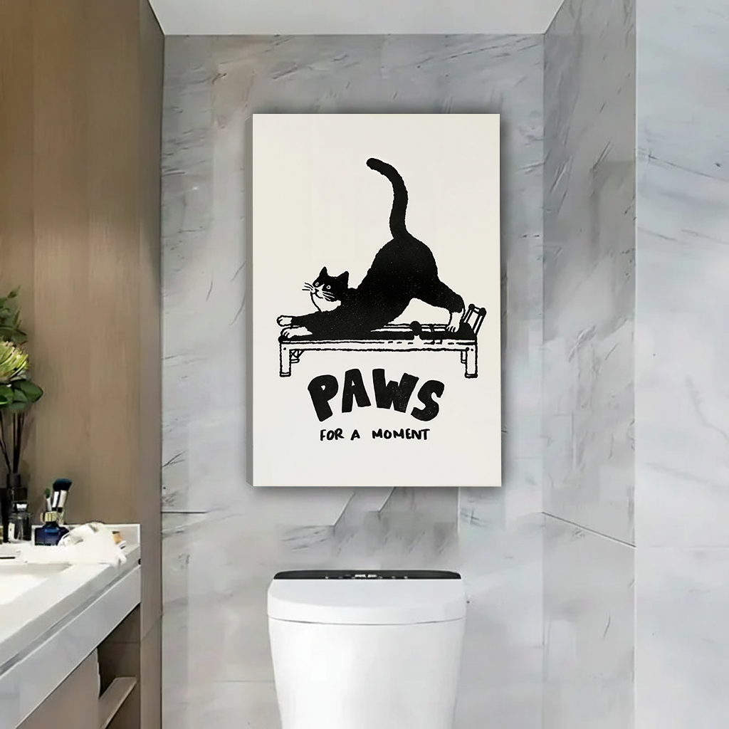 Black-framed Paws for a Moment cat canvas wall art featuring retro lettering against a marble bathroom wall.