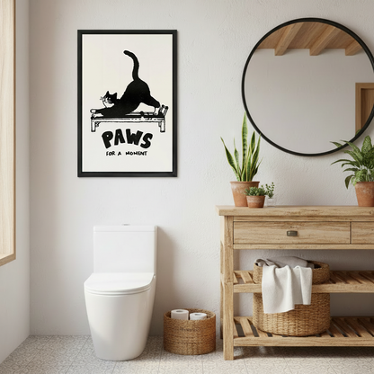 Two women smiling beside framed Paws for a Moment cat canvas wall art featuring a black cat on a reformer.