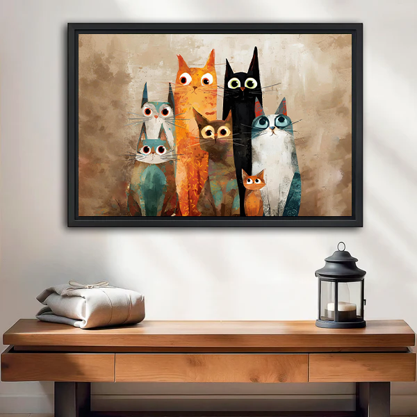 Framed whimsical quirky cat family canvas wall art hanging above a bed with crisp white bedding