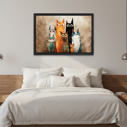 Smiling woman holding a large framed quirky cat family canvas wall art in a bright room, showing scale