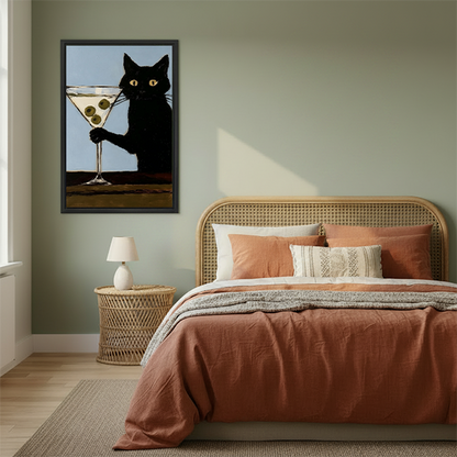 Retro black cat martini framed canvas wall art beside rattan headboard in warm bedroom with sage green walls and terracotta bedding