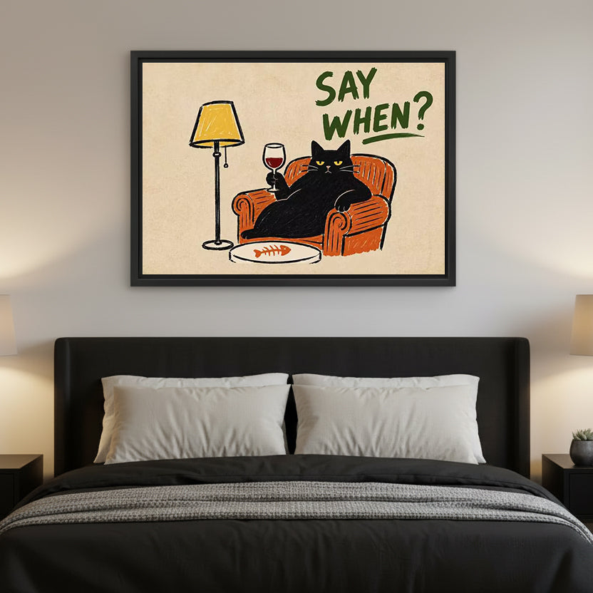 Framed retro black cat wine canvas wall art hanging above a bed with dark bedding and bedside lamps.