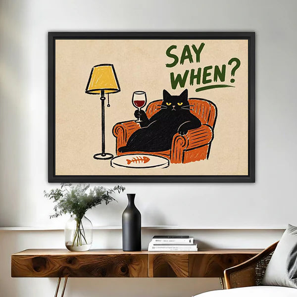 Retro black cat wine canvas wall art in a black frame above a wooden console table with a vase.
