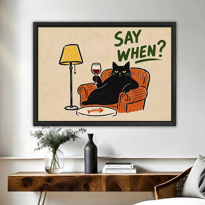 Retro black cat wine canvas wall art in a black frame above a wooden console table with a vase.