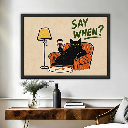 Retro black cat wine canvas wall art in a black frame above a wooden console table with a vase.