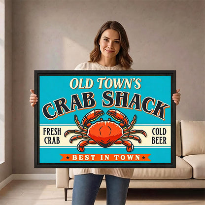 Smiling woman holding framed retro crab shack sign wall art with orange crab and cold beer text