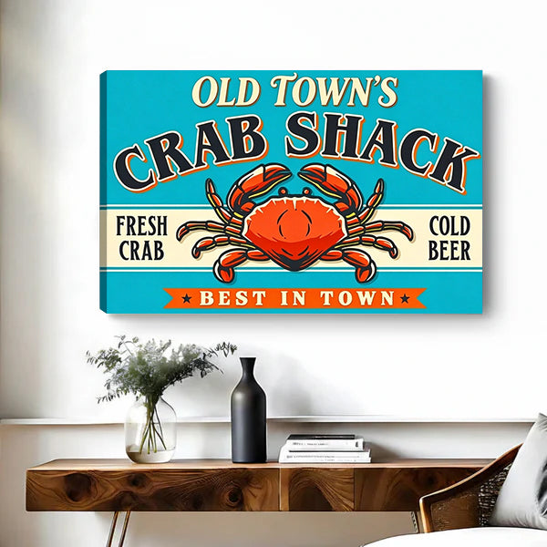Gallery-wrap crab shack sign canvas wall art showing the left canvas edge above a wooden console
