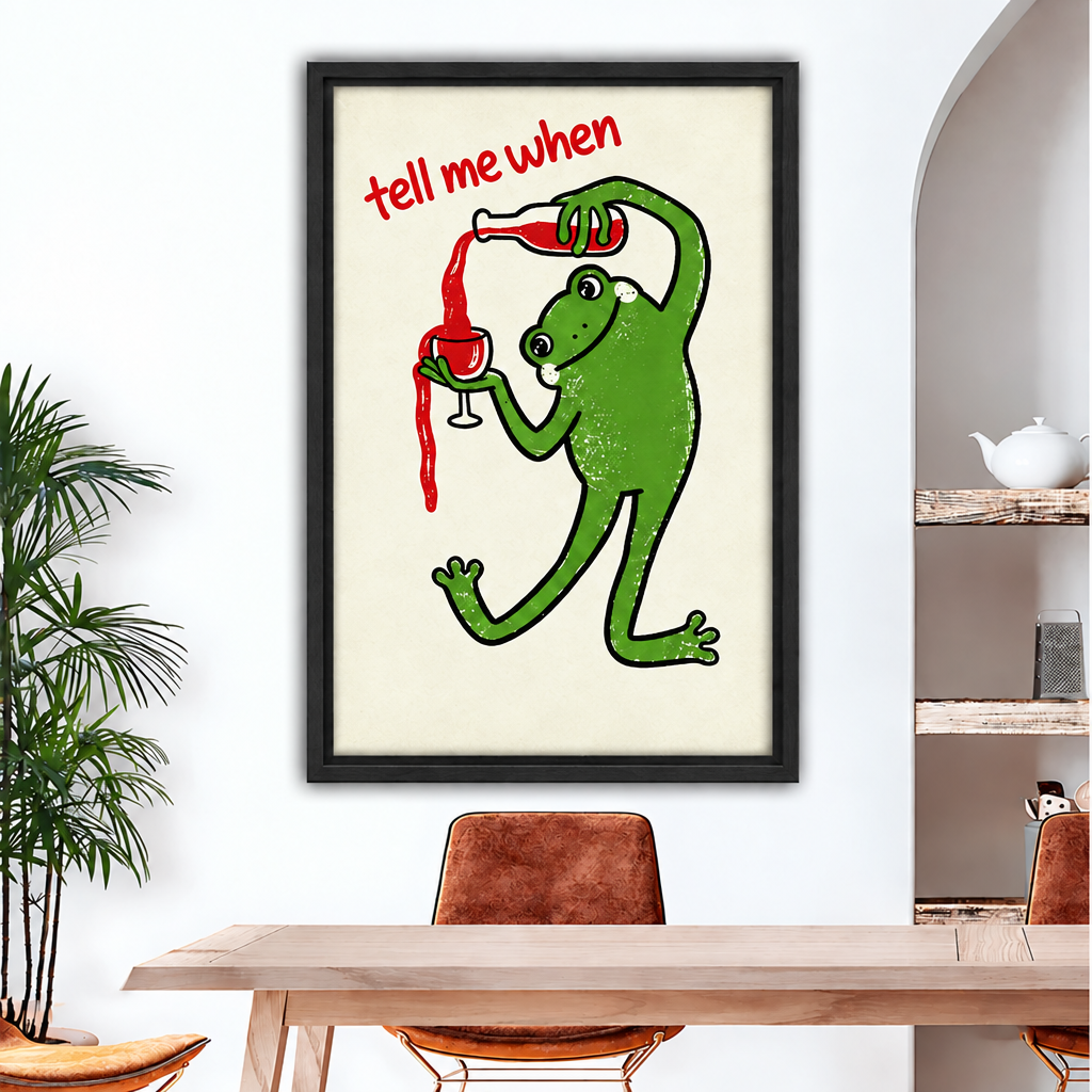 Framed retro wine frog canvas wall art above a wooden dining table with tan leather chairs