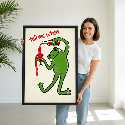 Smiling woman holding framed retro wine frog canvas wall art with the tell me when quote