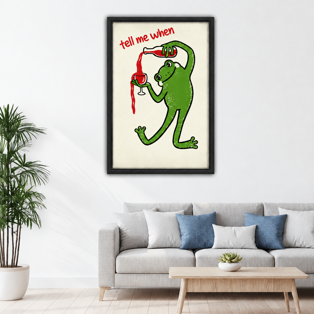 Black framed retro wine frog canvas wall art above a grey sofa with blue and white cushions