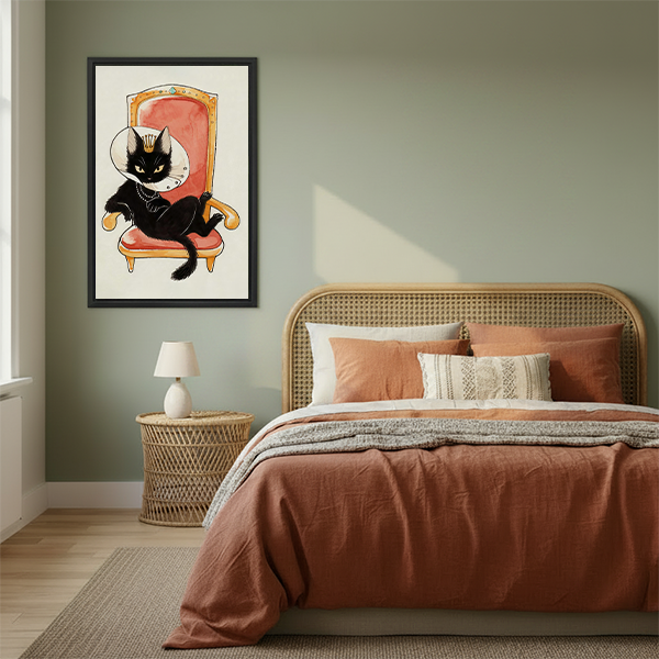 Woman holding black-framed royal black cat canvas wall art showing a crowned cat in a recovery cone on a throne.