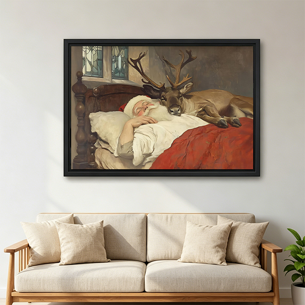 Vintage Santa and reindeer canvas wall art in a black frame above white bedding and a wooden headboard.