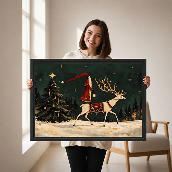 Woman holding framed Santa and reindeer canvas wall art featuring a decorated Christmas tree and snowy forest.