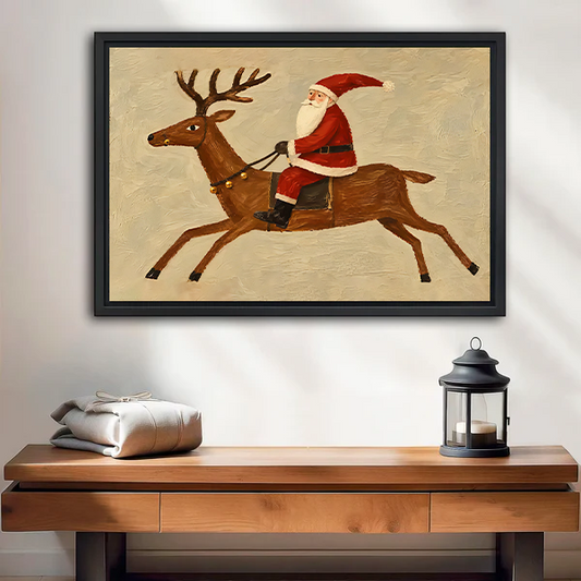 Rustic Santa riding reindeer canvas wall art in a black frame above a cream sofa with wooden arms.