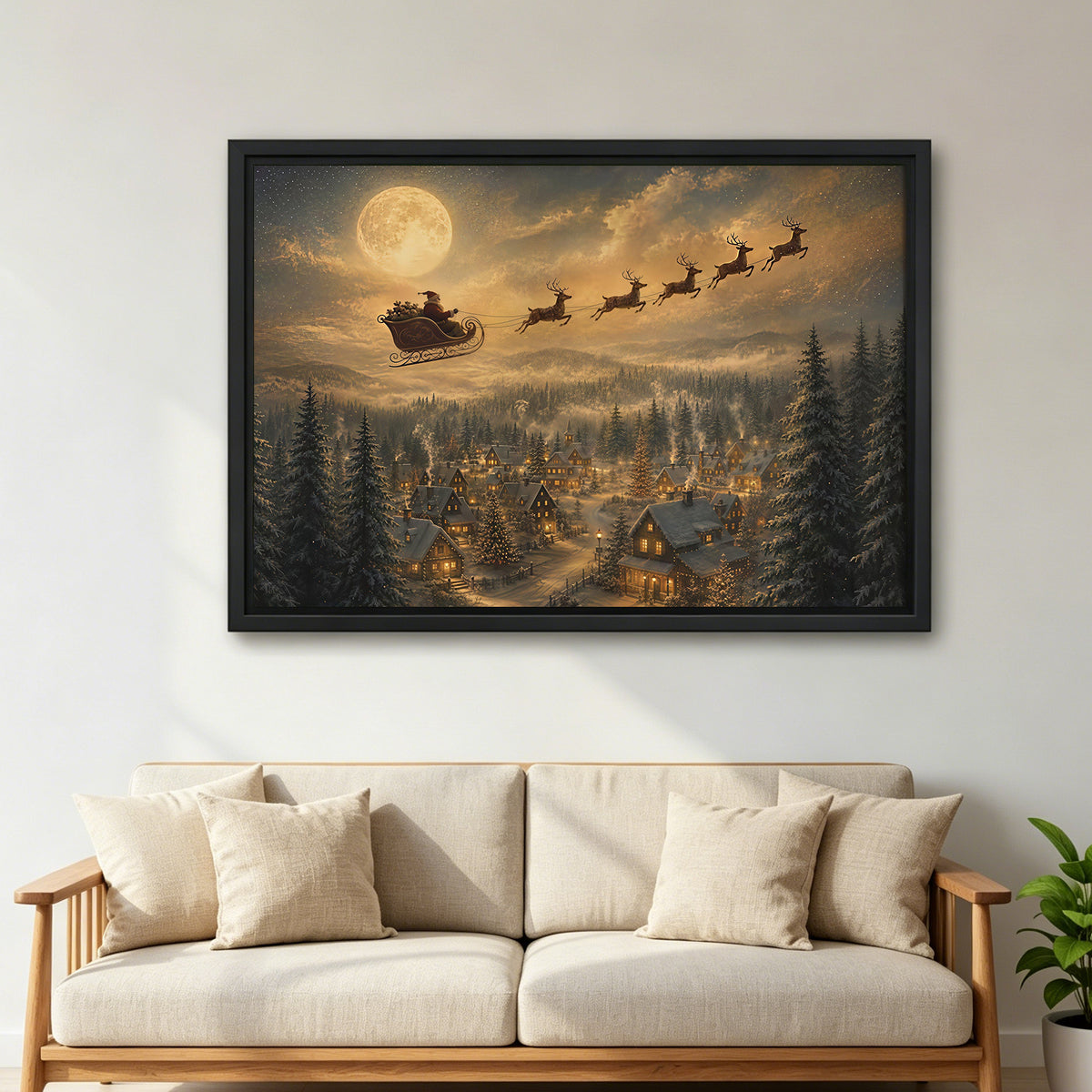 Large framed Santa sleigh canvas wall art showing a moonlit snowy village above a cream living room sofa.
