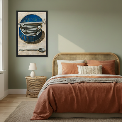 Black framed vintage sardine tin canvas wall art displayed above a cream sofa in a bright living room.