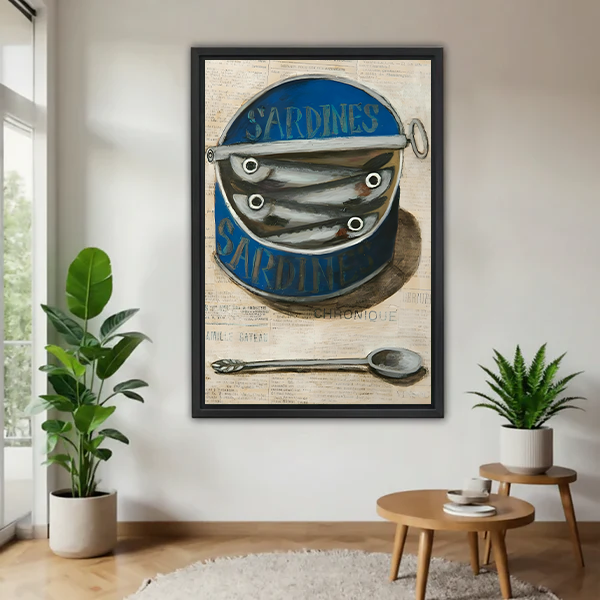 Framed vintage sardine tin canvas wall art with a blue can and spoon, displayed between green houseplants.