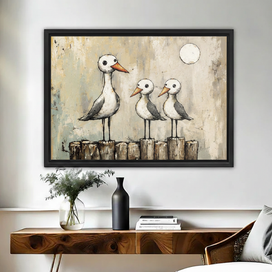 Seagull family vintage framed canvas wall art above rustic wood console with vase in warm neutral living room