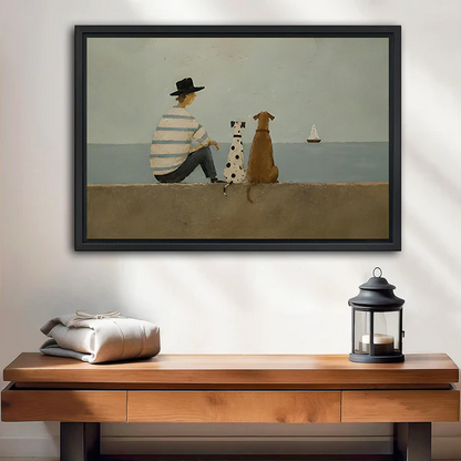 Framed seaside dogs canvas wall art with a seated figure and distant sailboat above a bed with white bedding.