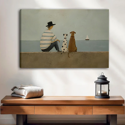 Woman holding framed seaside dogs canvas wall art showing a striped-shirt figure and two dogs facing the sea.