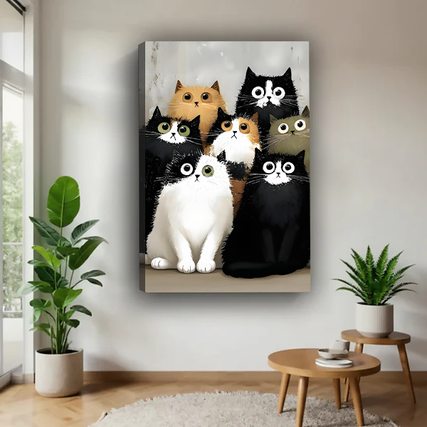 Whimsical seven cats canvas wall art in a black frame beside a rattan bed with terracotta bedding.
