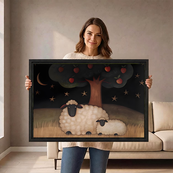 Black-framed sheep and apple tree canvas wall art above a black console table with plants and stacked books.
