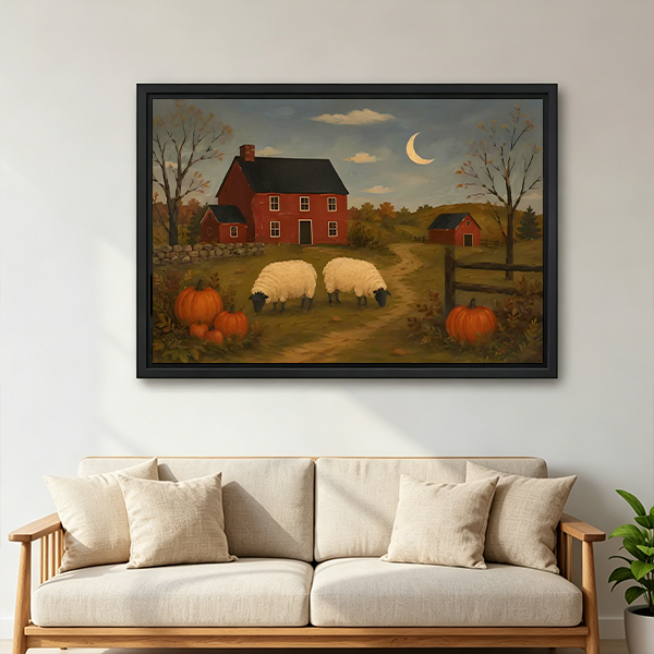 Woman holds framed sheep farm canvas wall art featuring a red farmhouse, pumpkins, and a crescent moon.
