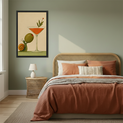 Framed snail cocktail canvas wall art displayed beside a rattan bed with terracotta bedding against a green wall.