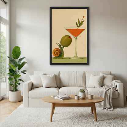 Woman holding framed snail cocktail canvas wall art showing a green snail lifting an olive beside an orange drink.