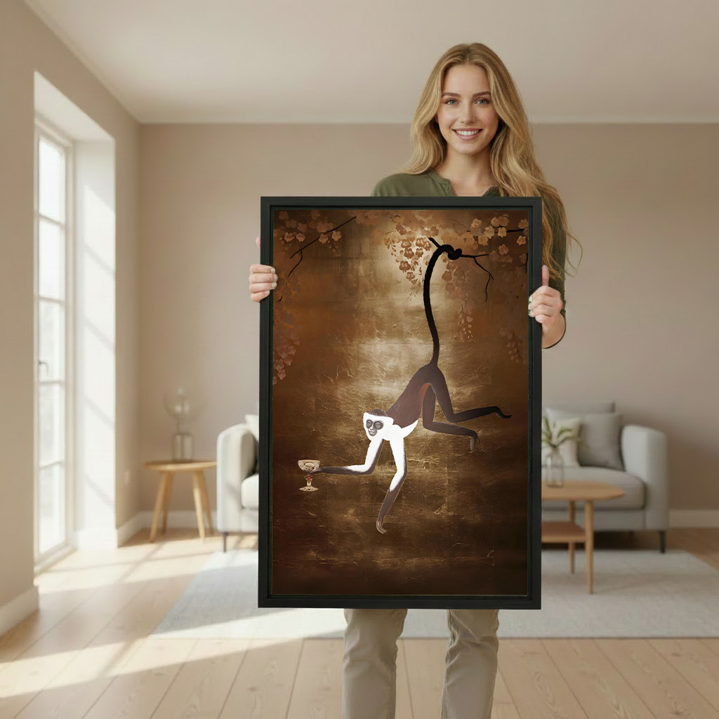Woman holding a large framed spider monkey art print to show size scale in a bright interior