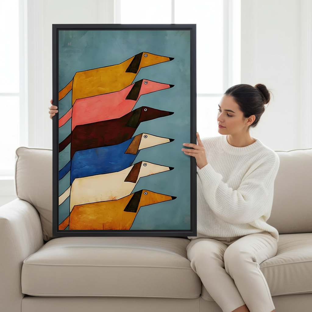Woman holding large framed stacked dachshunds folk art canvas print showing size scale on white sofa