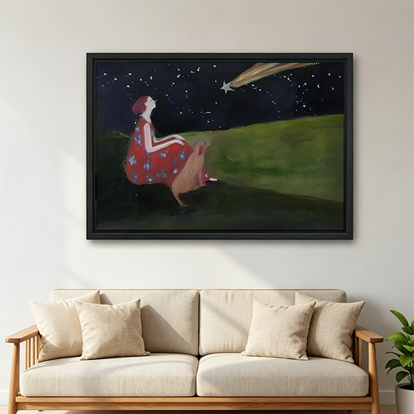 Stargazing girl and deer framed art print with shooting star and starry night sky displayed as bedroom wall decor above a white linen bed with wooden headboard