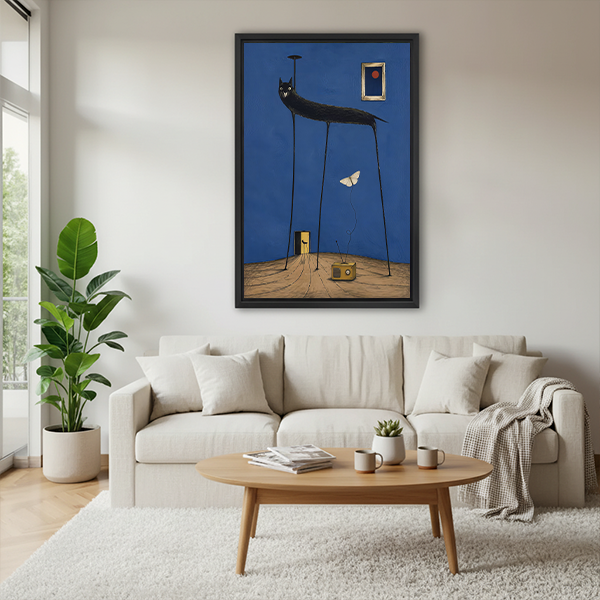 Framed surreal black cat canvas wall art with blue background displayed above a cream sofa in a bright living room.