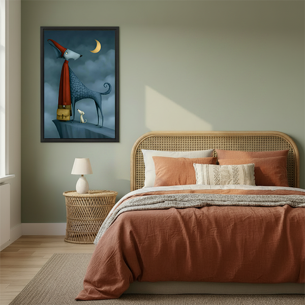 A woman holds framed whimsical blue dog moon artwork, showing the portrait canvas at human scale.