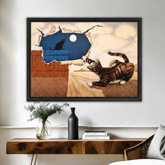 Surrealist cat canvas wall art in black frame displayed above wooden sideboard with vases and books