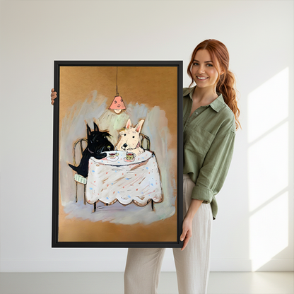 Woman holding black-framed terrier tea party canvas wall art featuring black and cream dogs at a cloth-covered table.