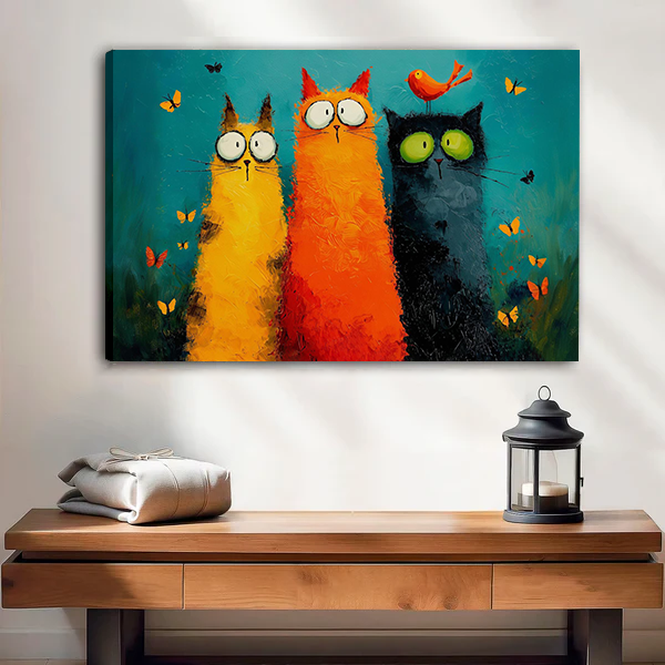 Woman holding framed three cats canvas wall art featuring colorful felines, butterflies, and a small orange bird.
