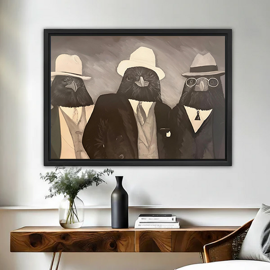 Three dapper crows in suits and hats framed wall art displayed above a wooden console table