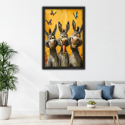 Framed canvas art print of three funny donkeys and colorful butterflies on a warm yellow background, styled above a light grey sofa in a modern living room