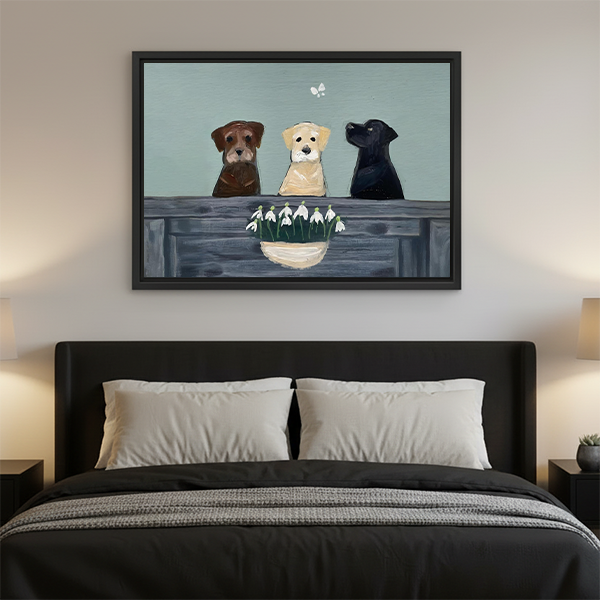 Three Labrador dogs snowdrop canvas wall art in black frame displayed above bed as bedroom wall decor