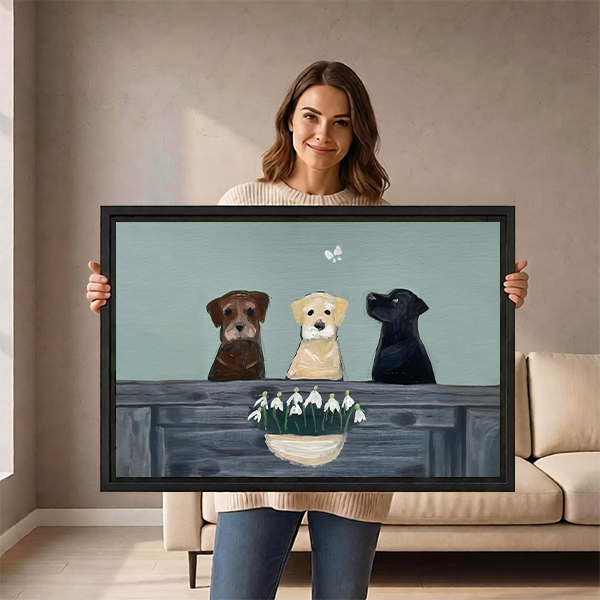 Woman holding three Labrador dogs snowdrop framed canvas wall art showing size in living room