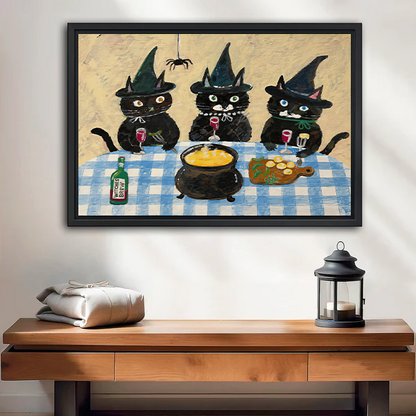 Framed three witch cats canvas wall art with a blue gingham table above a cream sofa with wooden arms.