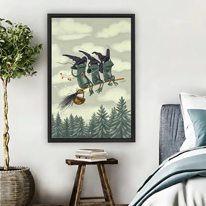 Three witch frogs flying on broomstick over pine forest framed canvas print hung on bedroom wall