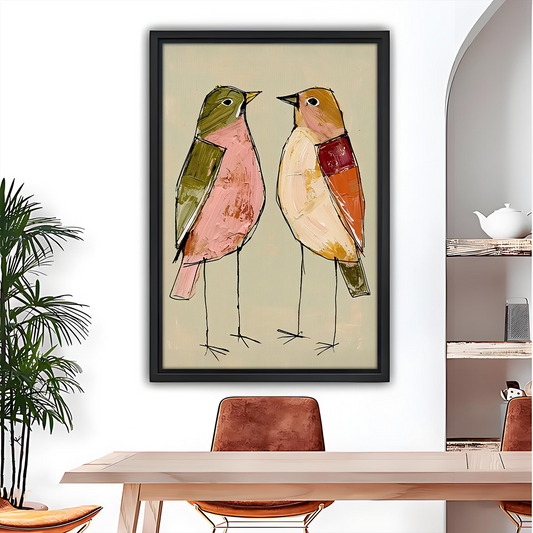 Whimsical two birds canvas wall art in a black frame above a gray sofa with blue and white cushions.