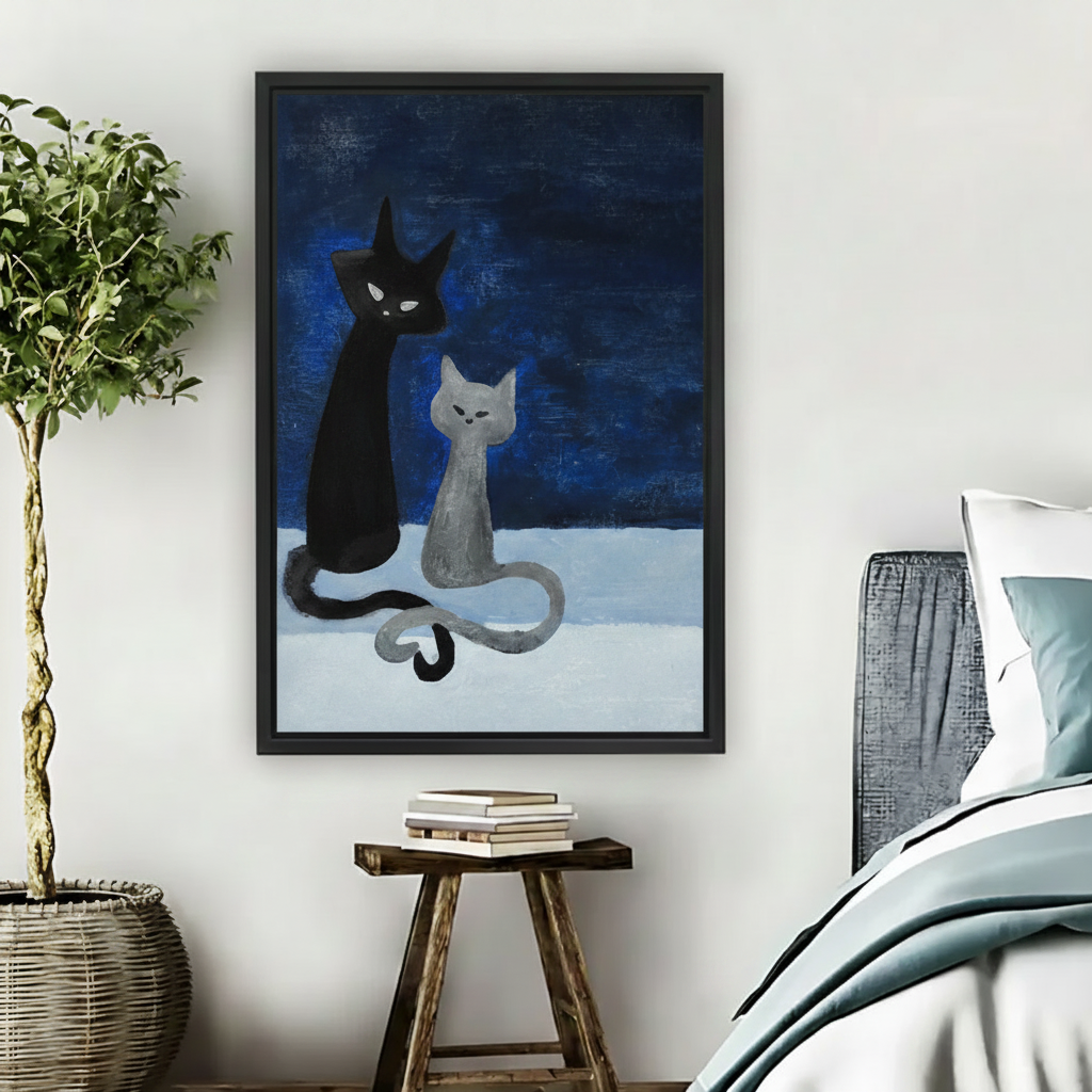 Whimsical black and grey cats folk art framed canvas hanging in bedroom next to plant and bed
