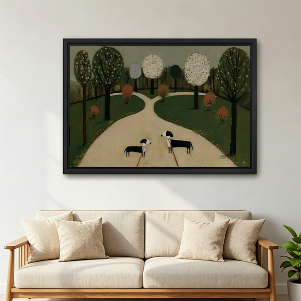 Two dogs park canvas wall art with muted green trees, black-framed above a cream sofa with wooden arms.