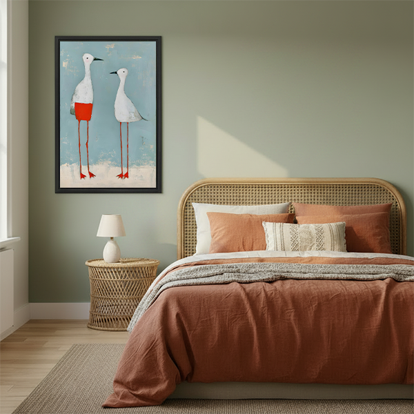 Framed two white birds canvas wall art with red legs above a cream living room sofa.