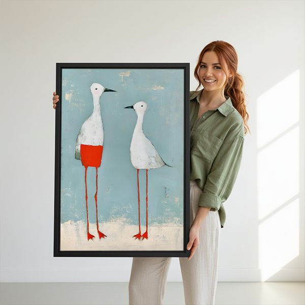 Framed two white birds canvas wall art hanging beside a bed with woven headboard.