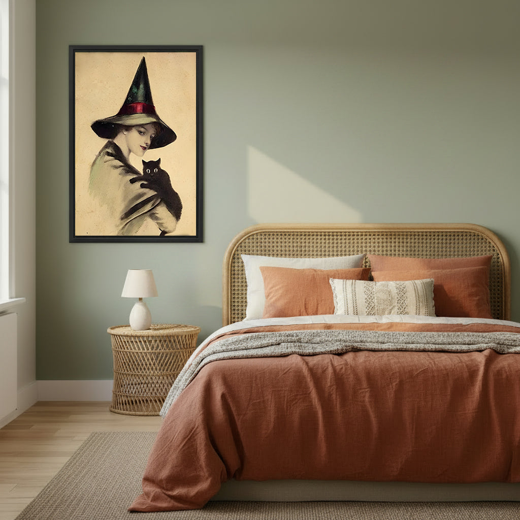 Victorian witch black cat vintage black framed canvas on sage green wall beside rattan headboard and terracotta linen bed