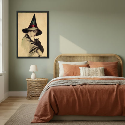 Victorian witch black cat vintage black framed canvas on sage green wall beside rattan headboard and terracotta linen bed